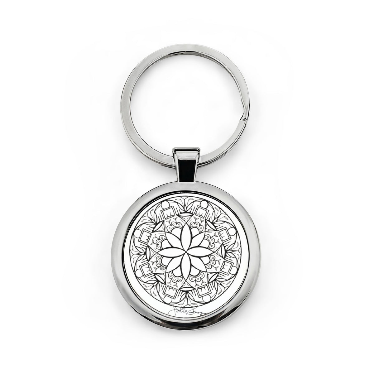 Silver keychain with a black and white mandala design on a white background